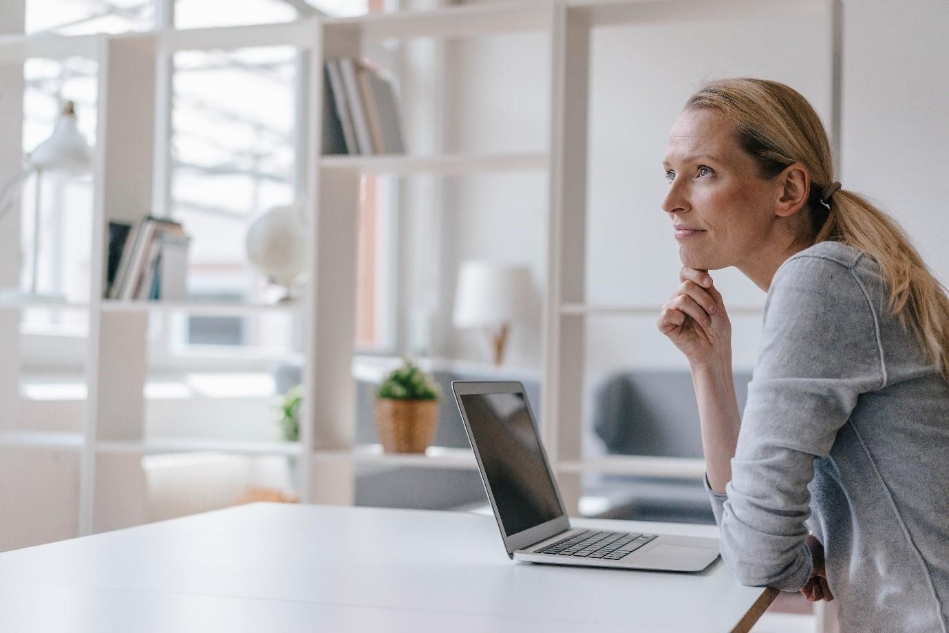 Person in thought with a laptop