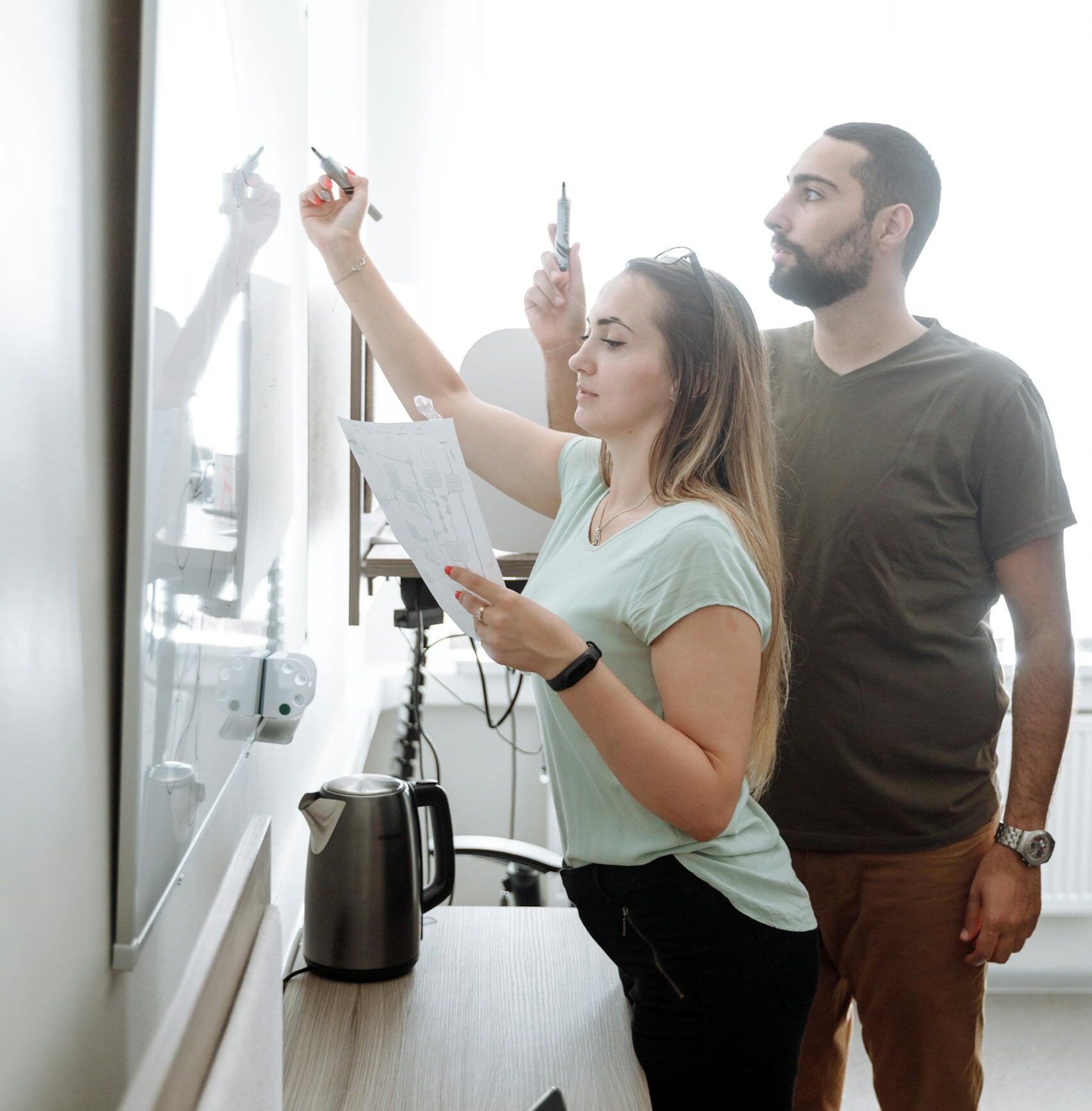 Man in Gray Crew Neck T-shirt Holding Woman in White Tank Top