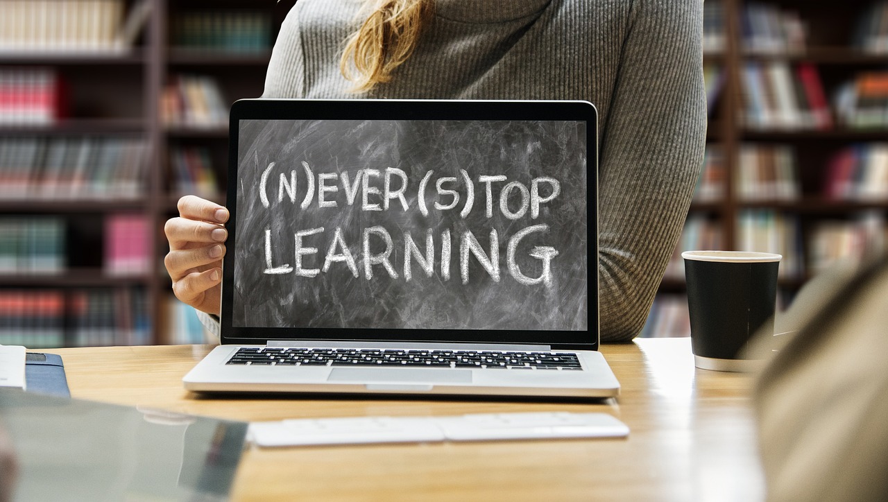 Image of a laptop showing 'never stop learning' as a slogan